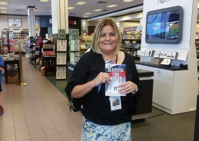 A patron displays her copy of Beautiful Evil Winter at Kelly K. Lavender's Barnes & Noble Booksigning