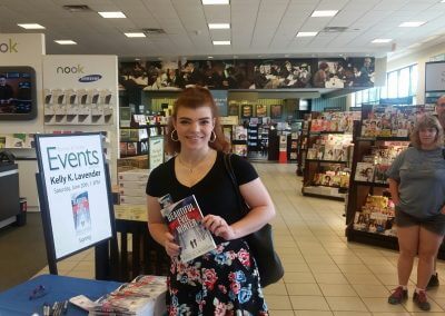 A patron displays her copy of Beautiful Evil Winter at Kelly K. Lavender's Barnes & Noble Booksigning